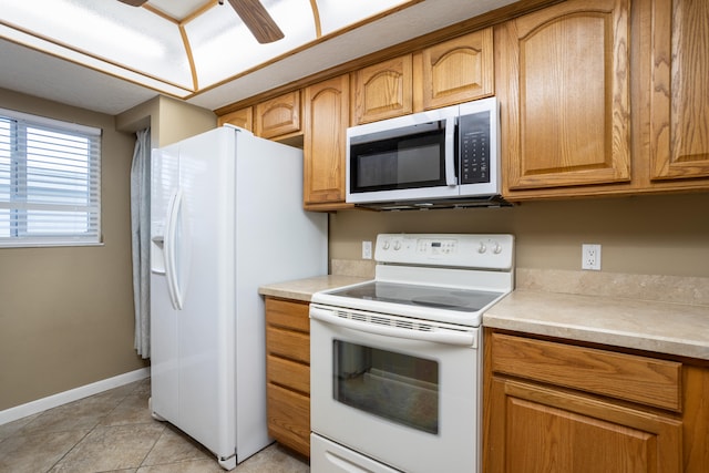 kitchen with light tile floors, ceiling fan, and white appliances