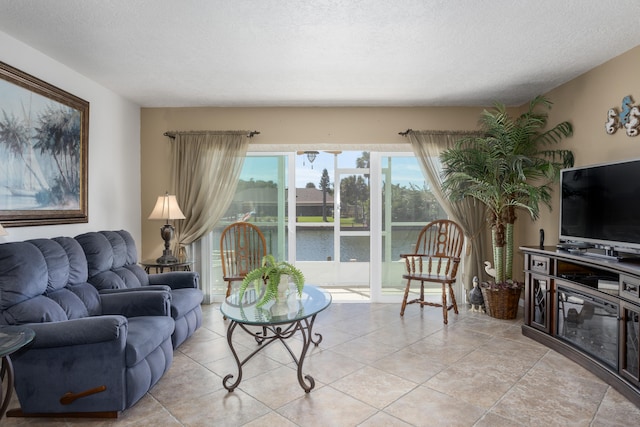 living room with light tile flooring and a textured ceiling