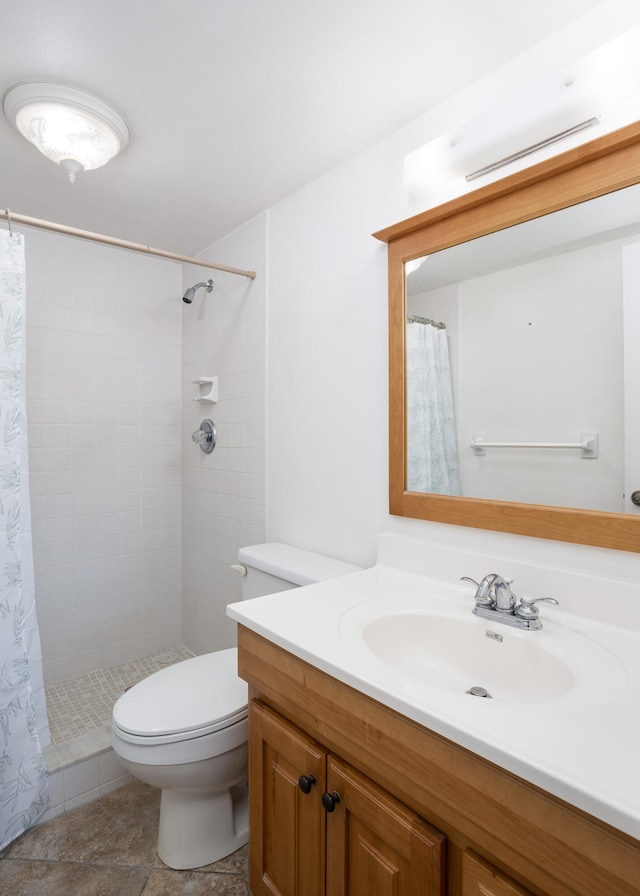 bathroom with vanity, walk in shower, tile floors, and toilet