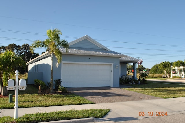 view of front of house with a front lawn and a garage