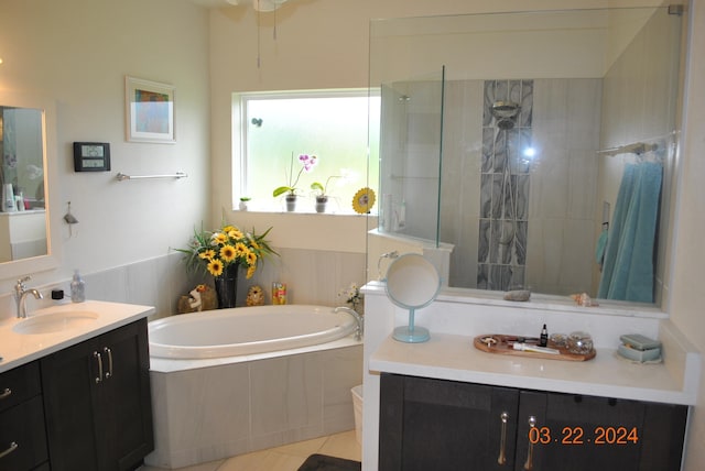 bathroom featuring plus walk in shower, tile floors, and vanity