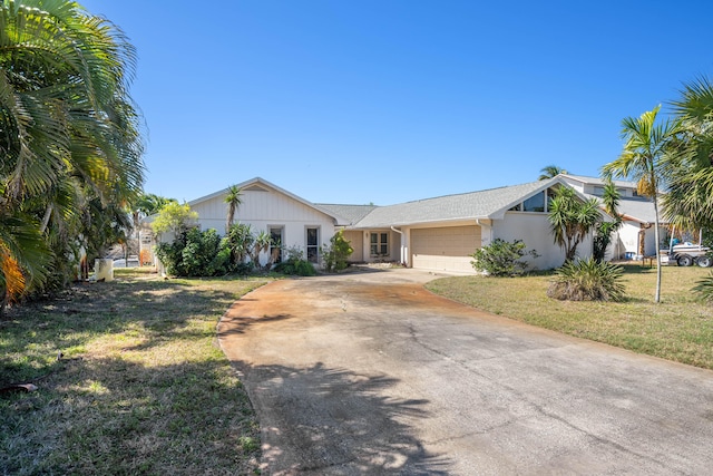 view of front facade featuring a front yard and a garage