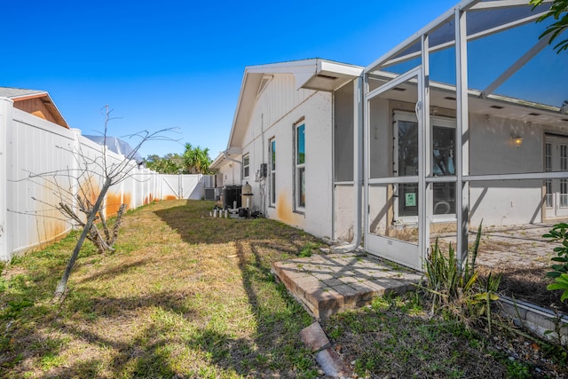 view of side of home featuring a lawn