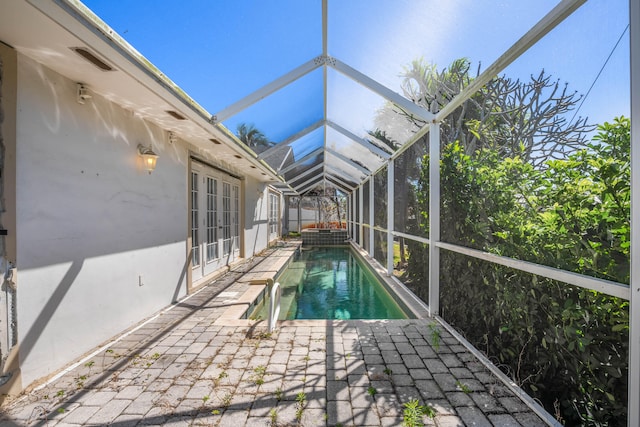 view of pool with a patio and a lanai