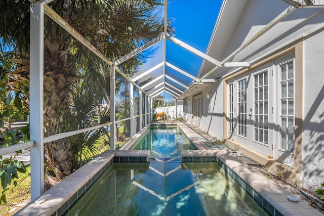 view of pool featuring french doors and glass enclosure