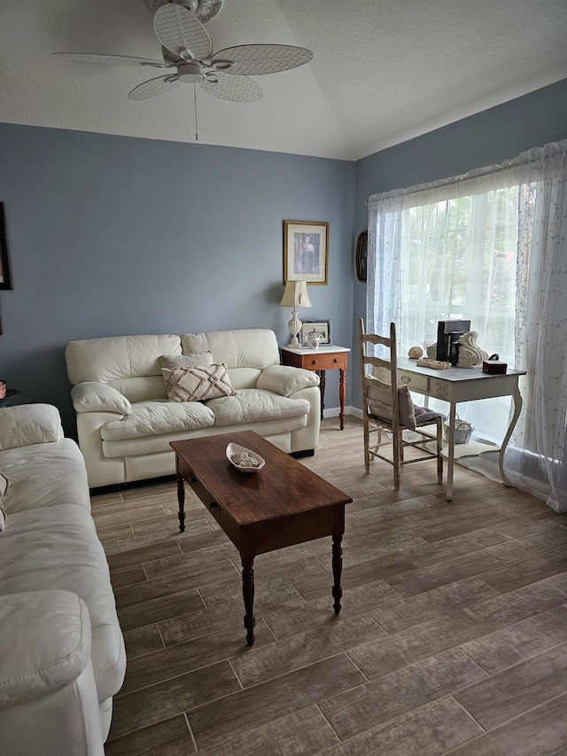 living room featuring a textured ceiling, ceiling fan, and dark hardwood / wood-style flooring