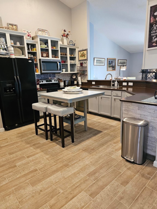 kitchen featuring tasteful backsplash, gray cabinets, light hardwood / wood-style flooring, appliances with stainless steel finishes, and sink