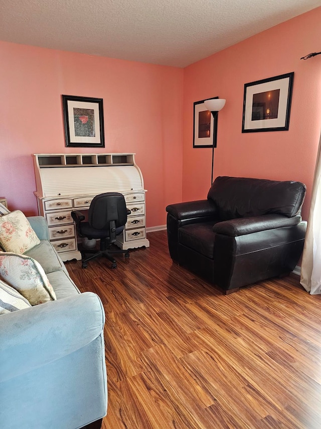 living room featuring hardwood / wood-style floors and a textured ceiling