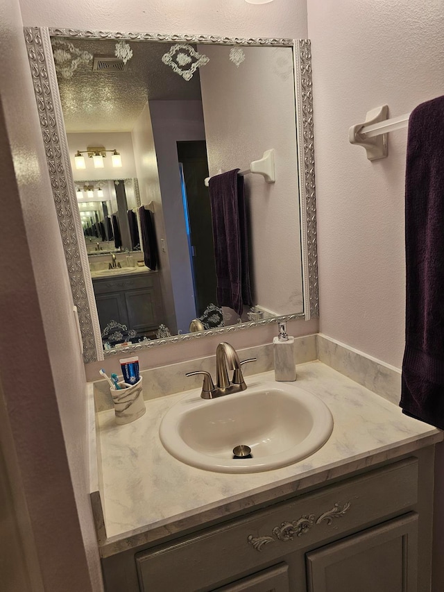 bathroom featuring vanity and a textured ceiling