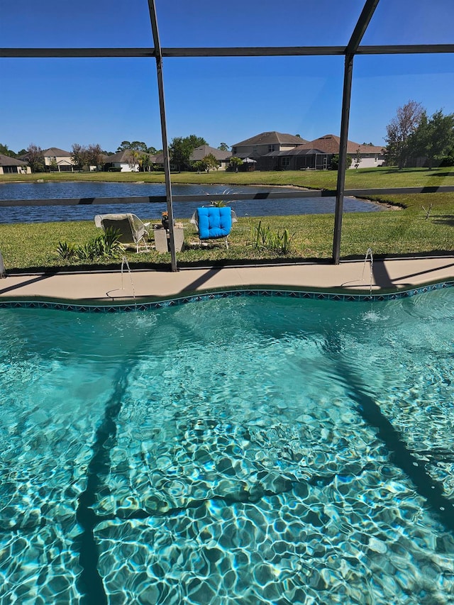 view of swimming pool featuring a lanai