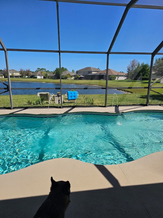 view of pool featuring a lawn, pool water feature, and a lanai