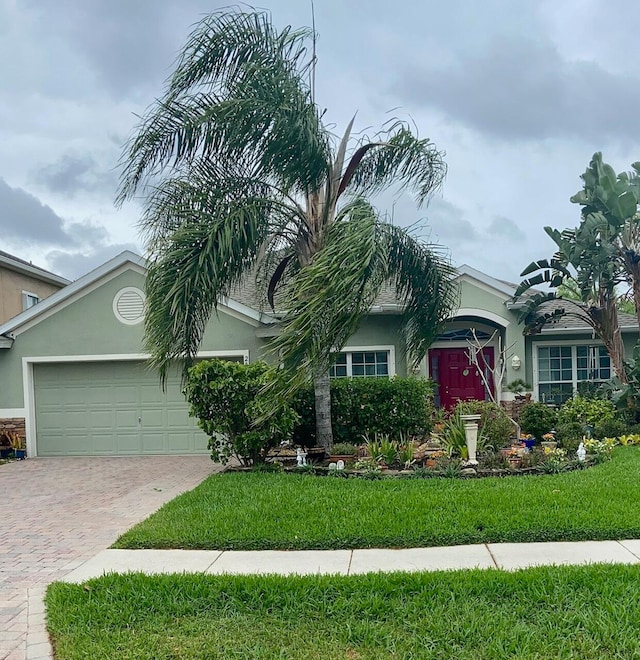 view of front of property with a front yard and a garage