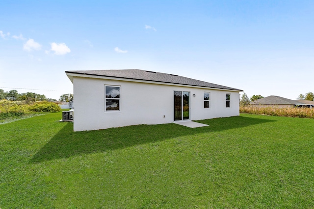 rear view of property with a lawn