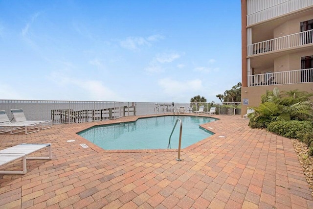 view of swimming pool featuring a patio area