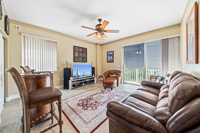 tiled living room featuring ceiling fan