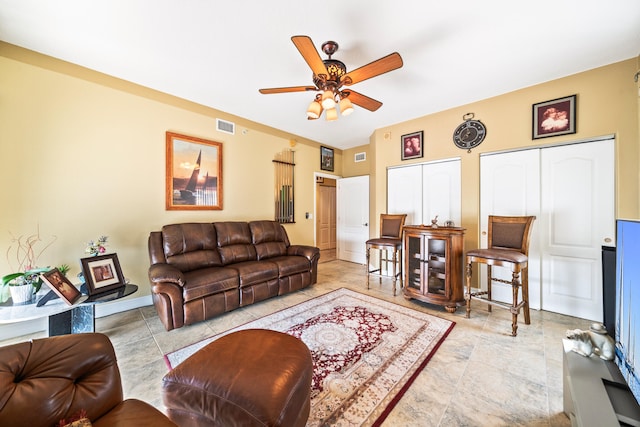 tiled living room featuring ceiling fan