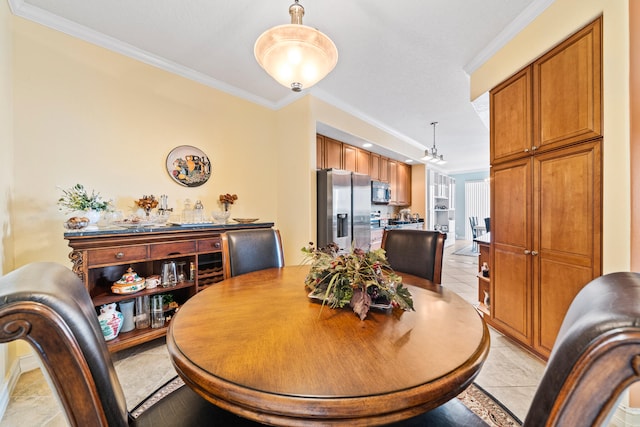 tiled dining room featuring ornamental molding