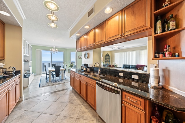 kitchen featuring sink, a textured ceiling, dark stone counters, stainless steel dishwasher, and ceiling fan with notable chandelier