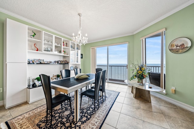 tiled dining area featuring a textured ceiling, an inviting chandelier, and crown molding