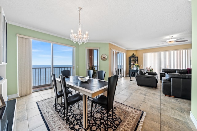 dining area with crown molding, a water view, ceiling fan with notable chandelier, and a healthy amount of sunlight