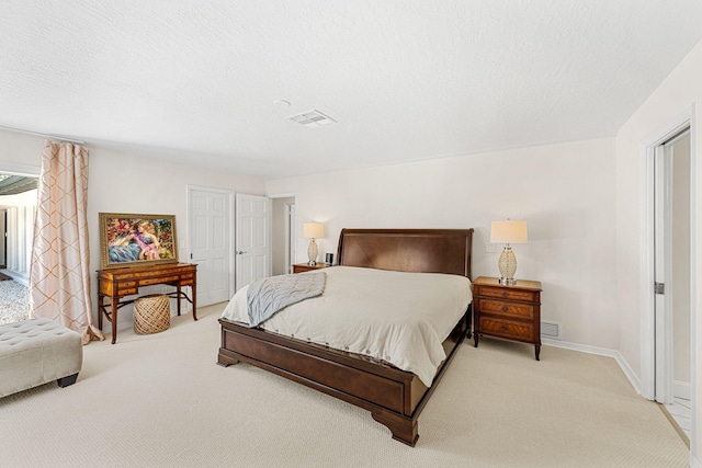 carpeted bedroom featuring a textured ceiling