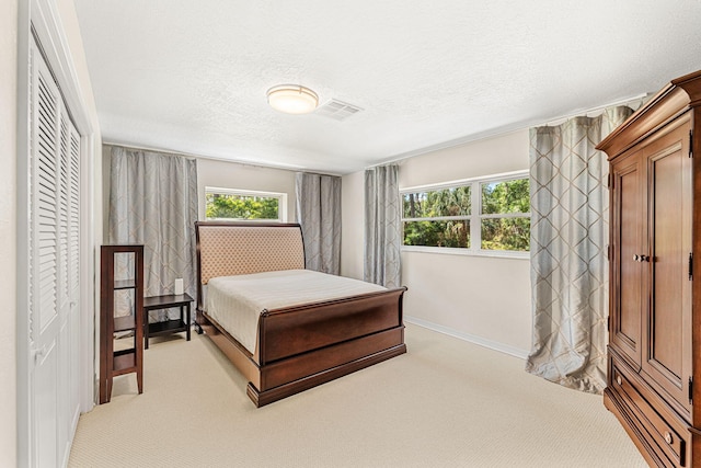 carpeted bedroom with a textured ceiling