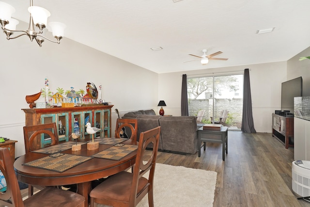 dining space with dark hardwood / wood-style floors and ceiling fan with notable chandelier