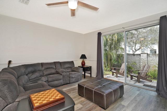 living room with wood-type flooring and ceiling fan