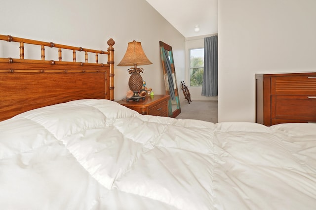 carpeted bedroom with lofted ceiling