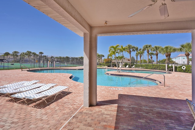 view of swimming pool featuring a patio and ceiling fan