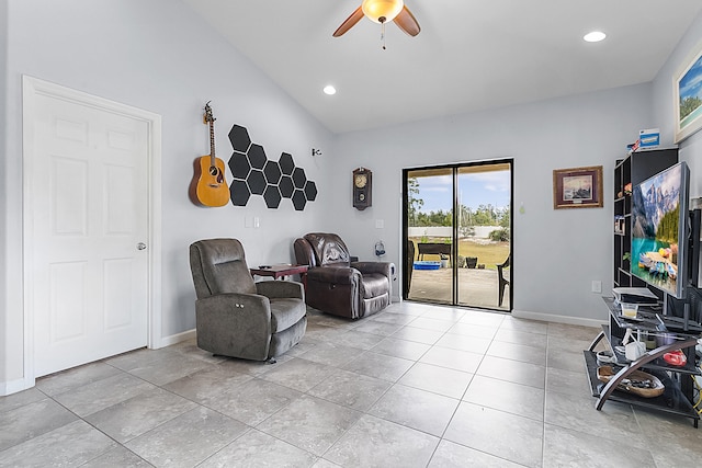 sitting room with light tile floors, vaulted ceiling, and ceiling fan