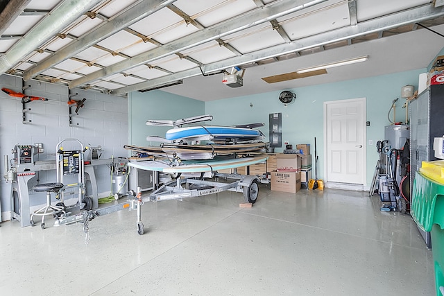 garage featuring a garage door opener and water heater