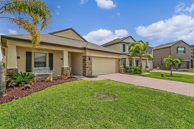 view of front of home with a front lawn and a garage