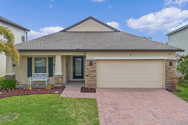 view of front facade featuring a front yard and a garage