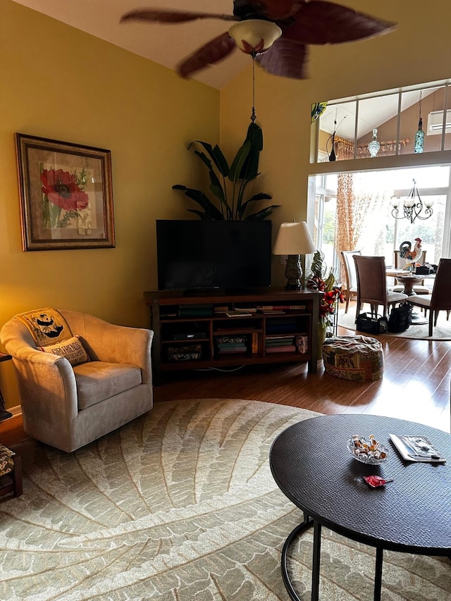 living room with ceiling fan, lofted ceiling, and hardwood / wood-style floors