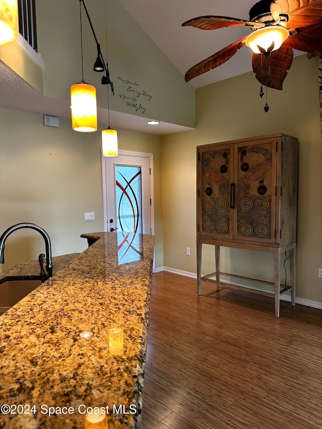 kitchen with sink, ceiling fan, lofted ceiling, decorative light fixtures, and dark hardwood / wood-style floors