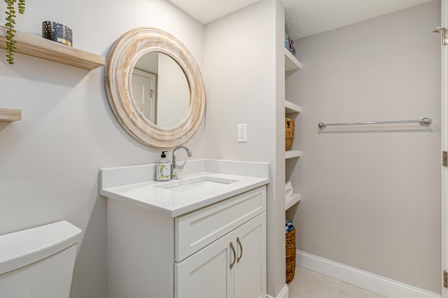 bathroom with toilet, tile floors, and large vanity