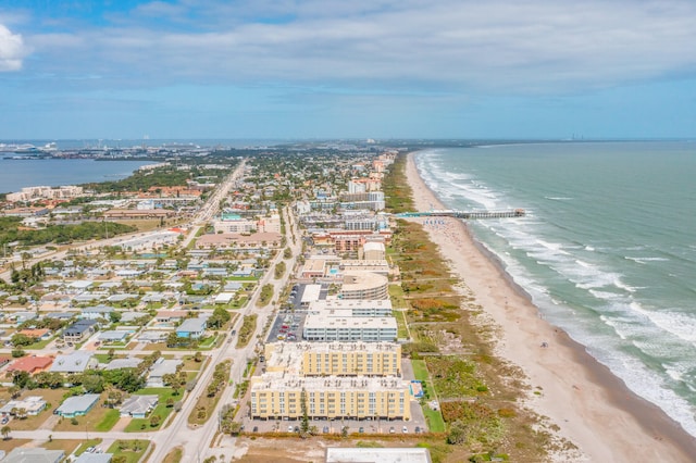 drone / aerial view featuring a beach view and a water view