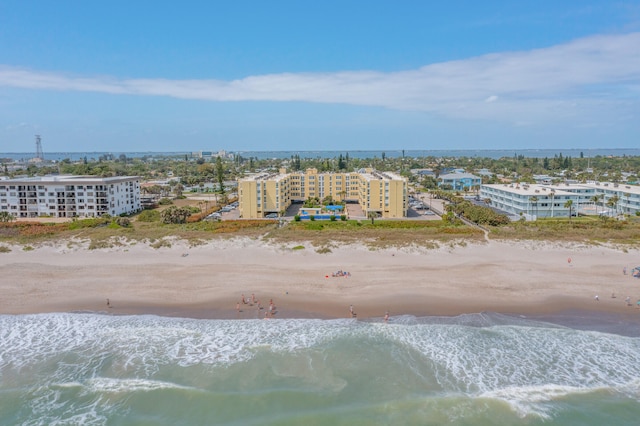 drone / aerial view with a beach view and a water view