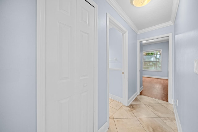 hall with crown molding and light tile flooring