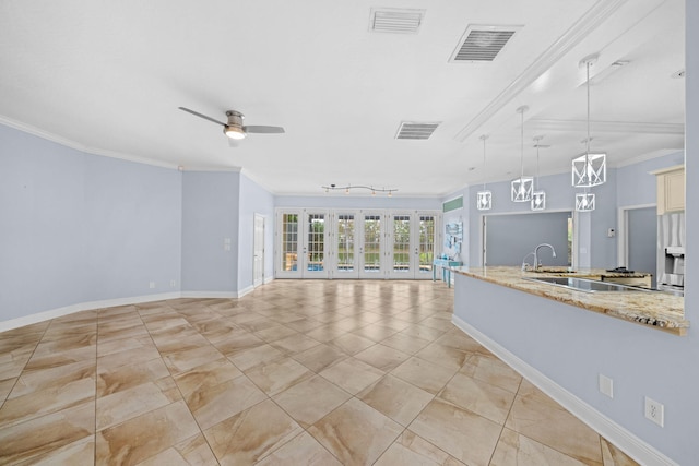 unfurnished living room featuring light tile floors, ceiling fan, french doors, crown molding, and track lighting