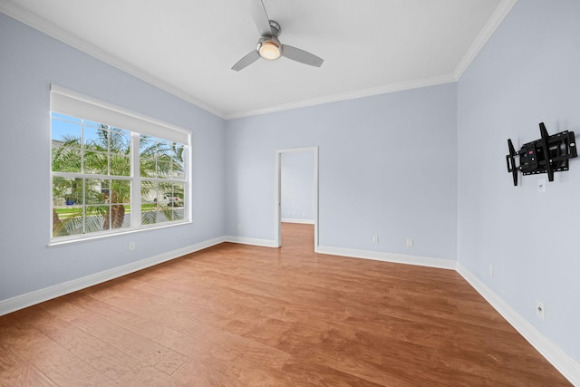 empty room with ceiling fan, crown molding, and light wood-type flooring