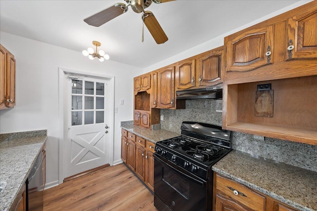 kitchen featuring stainless steel dishwasher, ceiling fan with notable chandelier, black gas range oven, tasteful backsplash, and light hardwood / wood-style flooring