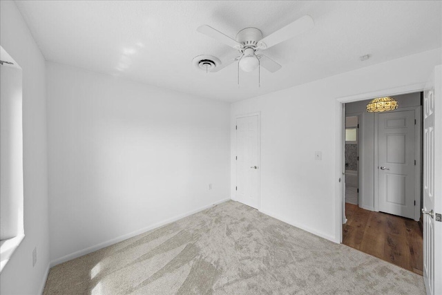 carpeted empty room with ceiling fan