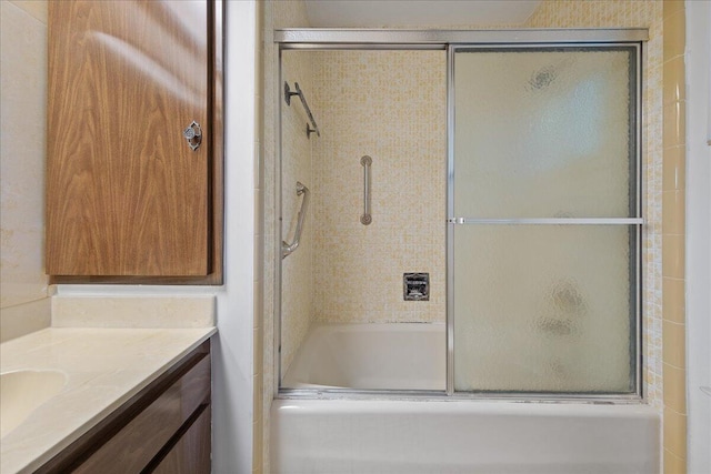 bathroom featuring vanity and enclosed tub / shower combo