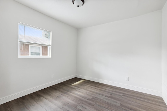 unfurnished room with dark hardwood / wood-style floors