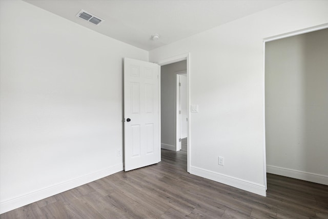 unfurnished room with dark hardwood / wood-style floors