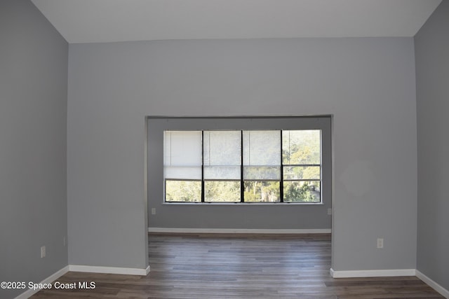 empty room with dark hardwood / wood-style flooring