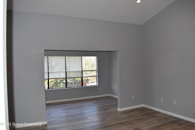 unfurnished room with dark wood-type flooring