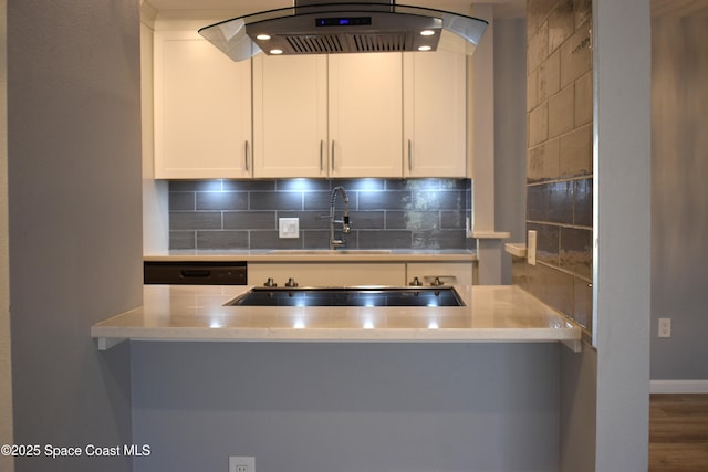 kitchen featuring extractor fan, dishwasher, white cabinets, hardwood / wood-style floors, and backsplash